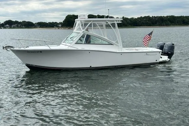 Slide: The Image of 2019 Albemarle 25 Express boat on water with American flag, overcast sky. - 11