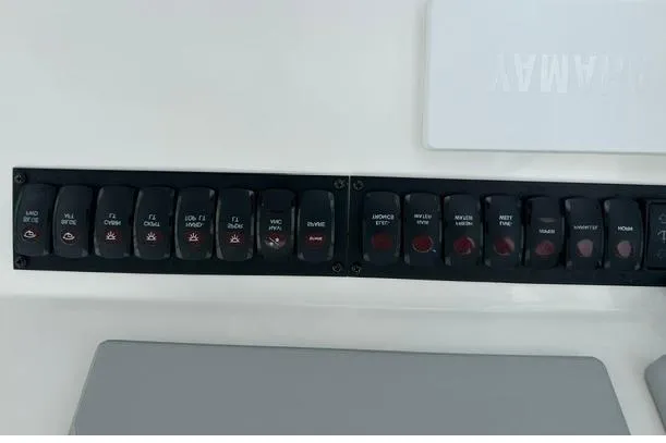 Slide: The Image of Control panel of a 2019 Albemarle 25 Express boat with labeled switches. - 14