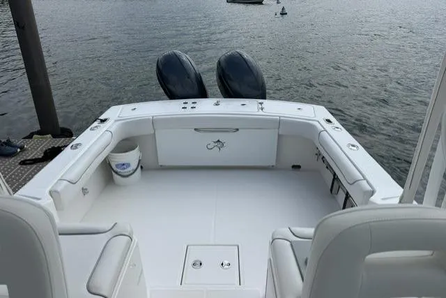 Slide: The Image of 2019 Albemarle 25 Express boat with spacious deck and dual outboard motors on water. - 22