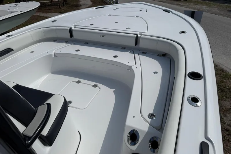 Slide: The Image of 2027 Tidewater 2500 Carolina Bay boat interior with seating and storage compartments. - 12