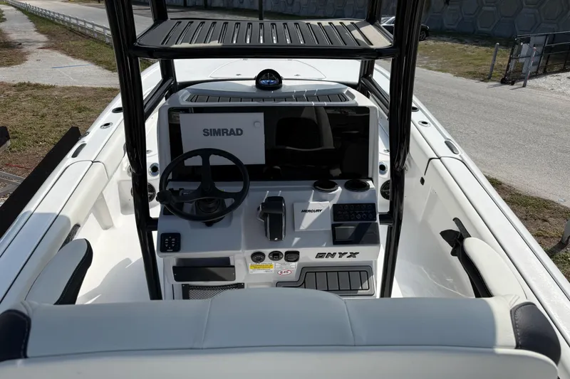 Slide: The Image of 2027 Tidewater 2500 Carolina Bay boat dashboard with Simrad navigation system and Mercury controls. - 9