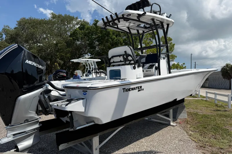 The Image of 2027 Tidewater 2500 Carolina Bay boat with Mercury engine on display outdoors. - 1