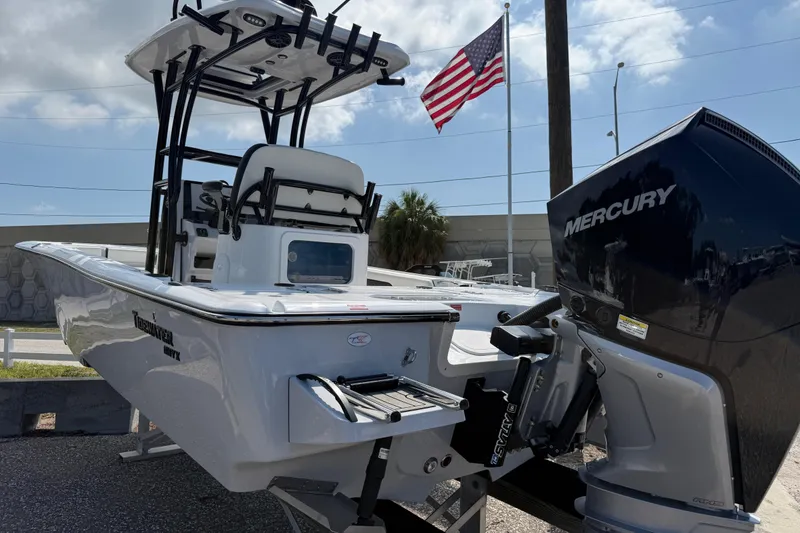 Slide: The Image of 2027 Tidewater 2500 Carolina Bay boat with Mercury engine, American flag in background. - 5