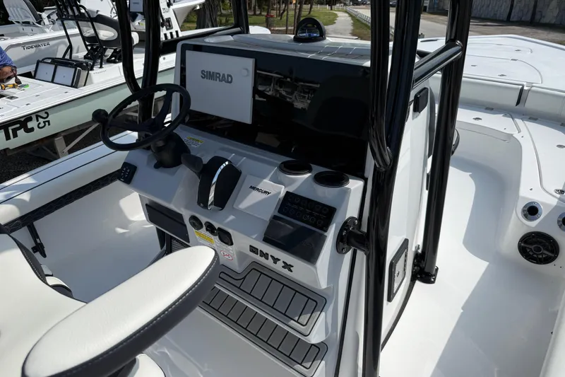 Slide: The Image of 2027 Tidewater 2500 Carolina Bay boat console with Simrad display and Mercury controls. - 11
