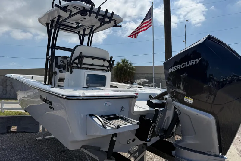 Slide: The Image of 2027 Tidewater 2500 Carolina Bay boat with Mercury engine, American flag in background. - 4
