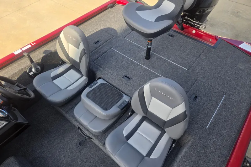 Slide: The Image of 2027 Lowe Stinger 175C boat interior with three gray seats and carpeted deck. - 6