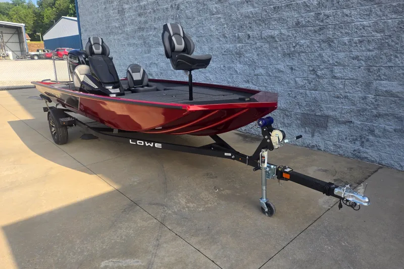 Slide: The Image of 2027 Lowe Stinger 175C boat in red, parked on a trailer outdoors. - 3