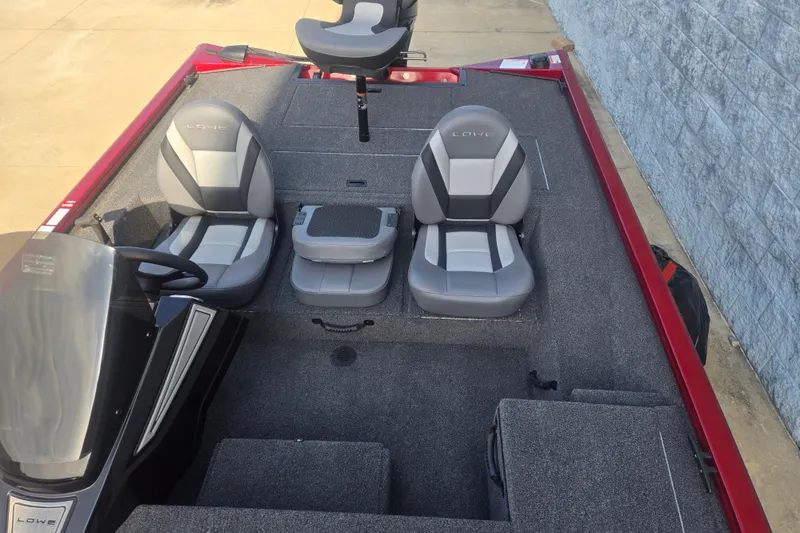 Slide: The Image of 2027 Lowe Stinger 175C boat interior with gray seating and carpeted deck. - 9