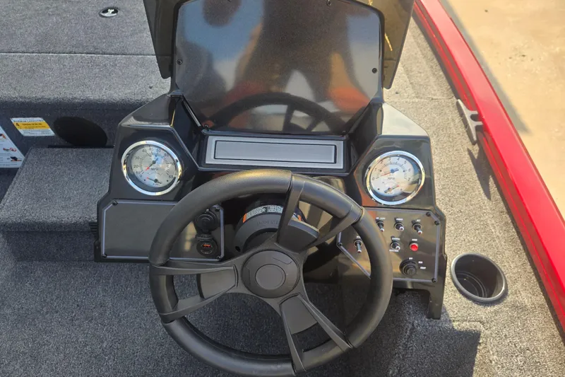 Slide: The Image of 2027 Lowe Stinger 175C boat dashboard with steering wheel and gauges. - 4