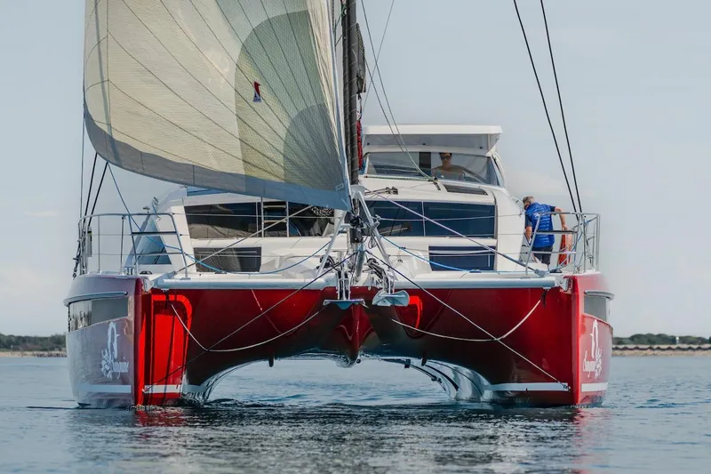 The Image of Red Privilege Signature 510 catamaran from 2025 on calm water. - 0