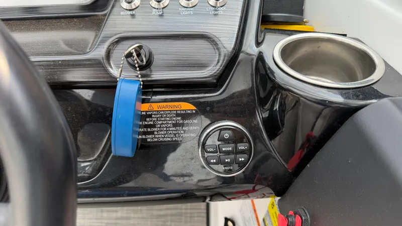 Slide: The Image of The image shows the dashboard of a Scarab 195 ID boat with controls and warning labels. - 35
