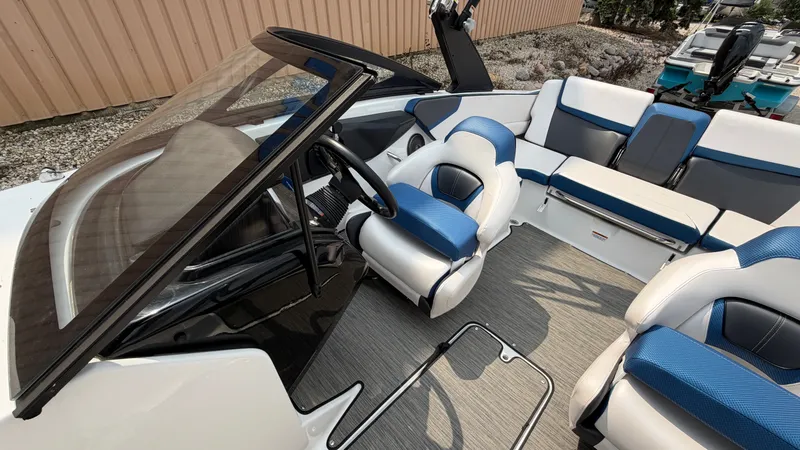 Slide: The Image of The image shows the cockpit of a 2023 Scarab 195 ID with blue and white seating. - 31