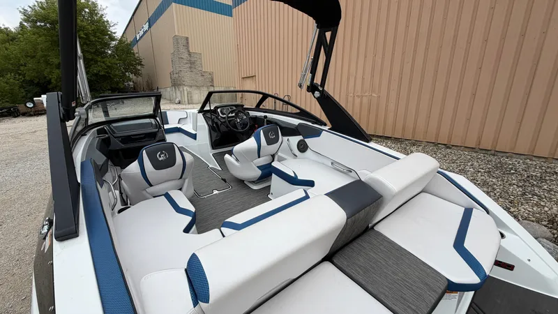 Slide: The Image of The image shows a modern 2023 Scarab 195 ID boat with stylish seating and sleek design. - 15