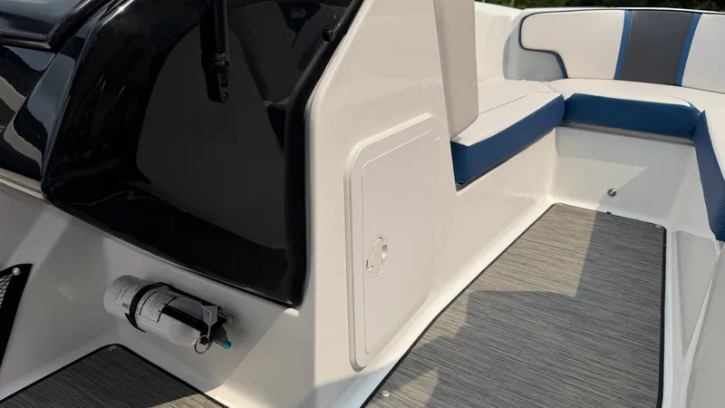 Slide: The Image of The image shows the interior of a 2023 Scarab 195 ID boat with modern seating and a fire extinguisher. - 40