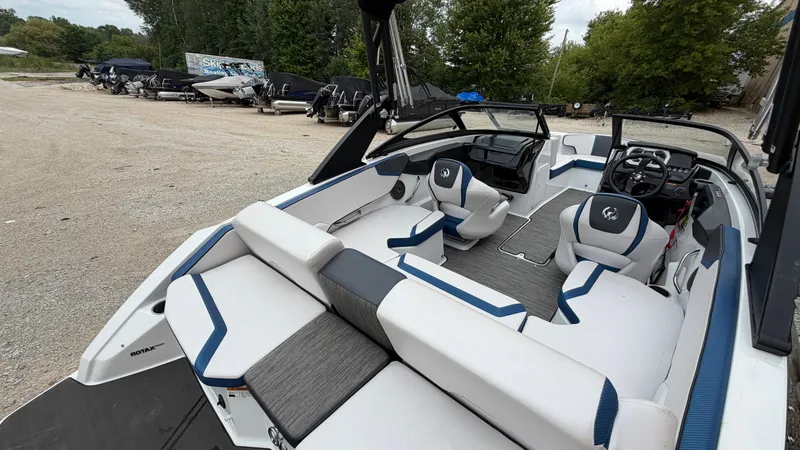 Slide: The Image of The image shows the interior of a 2023 Scarab 195 ID boat with modern seating and controls. - 14