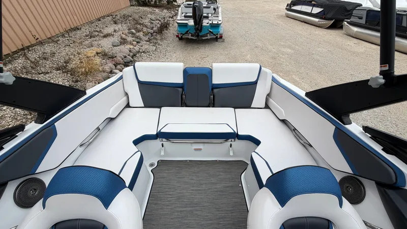 Slide: The Image of The image shows the interior of a 2023 Scarab 195 ID boat with blue and white seating. - 16
