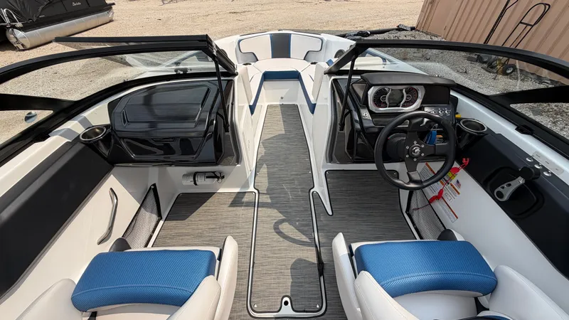 Slide: The Image of The image shows the cockpit of a 2023 Scarab 195 ID boat with blue and gray seating. - 39