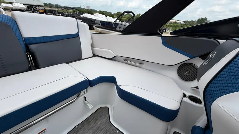 Slide: The Image of The image shows the interior of a 2023 Scarab 195 ID boat with blue and white seating. - 18