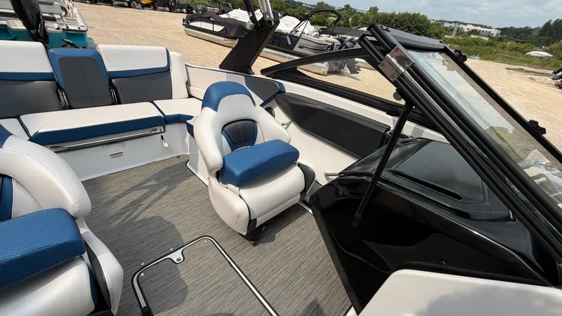 Slide: The Image of The image shows the interior of a 2023 Scarab 195 ID boat with blue and white seating. - 27