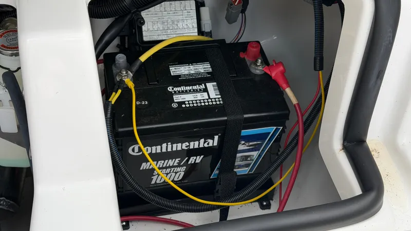 Slide: The Image of A marine battery in a boat engine compartment, connected with cables and fuses. - 25