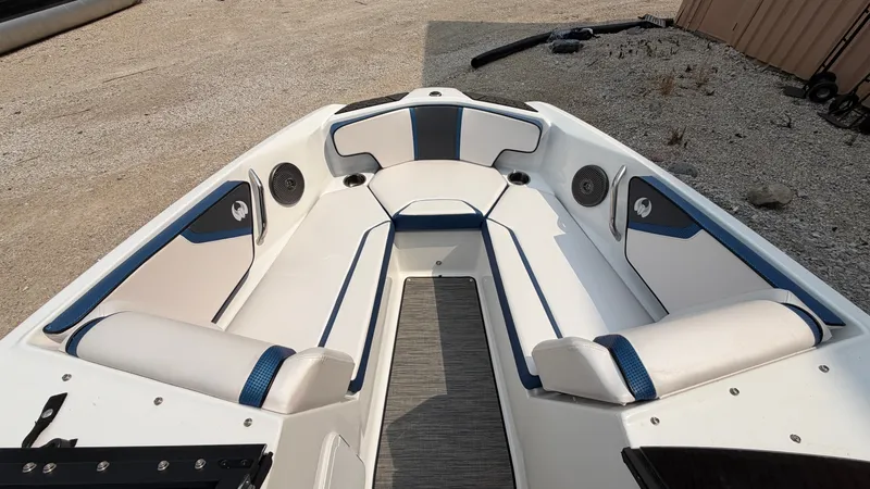 Slide: The Image of The image shows the cockpit of a 2023 Scarab 195 ID boat with white and blue seating. - 42