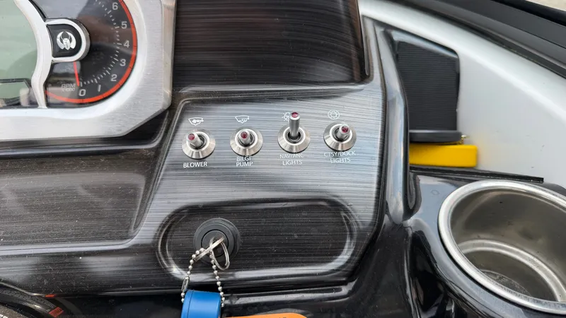 Slide: The Image of Dashboard of a Scarab 195 ID boat with switches and ignition key. - 34