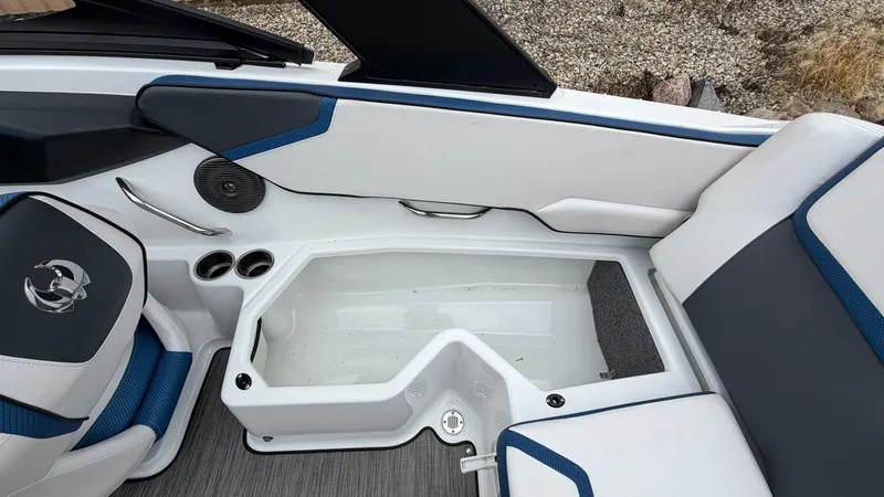 Slide: The Image of The image shows the interior of a 2023 Scarab 195 ID boat with seating and storage. - 19