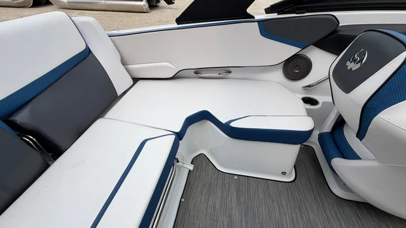 Slide: The Image of Interior of a Scarab 195 ID boat with blue and white seating. - 20