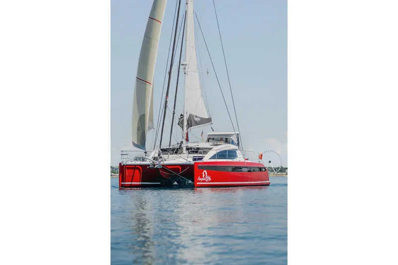 Slide: The Image of Red Privilege Signature 510 catamaran on calm water, year 2025. - 77