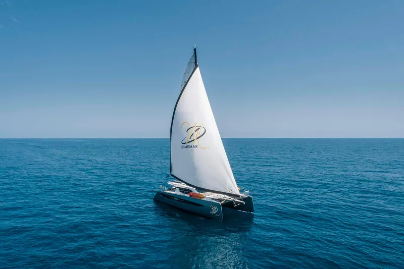 Slide: The Image of Sailing catamaran Privilege Signature 580, 2025 model, gliding on open sea under clear blue sky. - 6