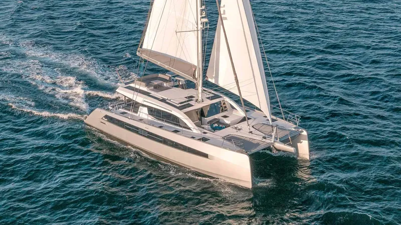 Slide: The Image of Luxury Privilege Signature 580 catamaran sailing on open sea, 2025 model. - 2