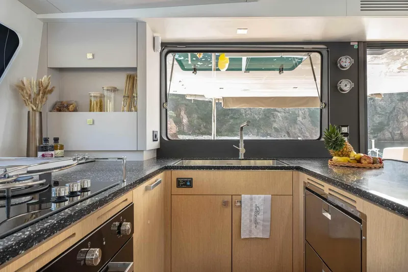 Slide: The Image of Modern kitchen interior on 2025 Privilege Signature 580 yacht, featuring sleek design and ocean view. - 34