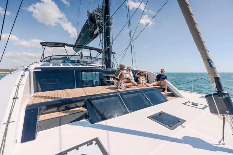 Slide: The Image of Luxury sailing on 2025 Privilege Signature 650 yacht with people relaxing on deck. - 13