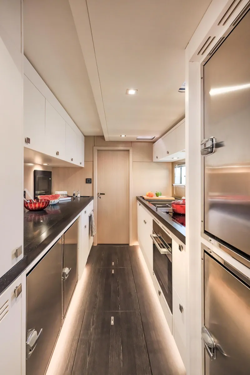 Slide: The Image of Modern galley kitchen in 2025 Privilege Signature 650 yacht, featuring sleek cabinetry and stainless steel appliances. - 36