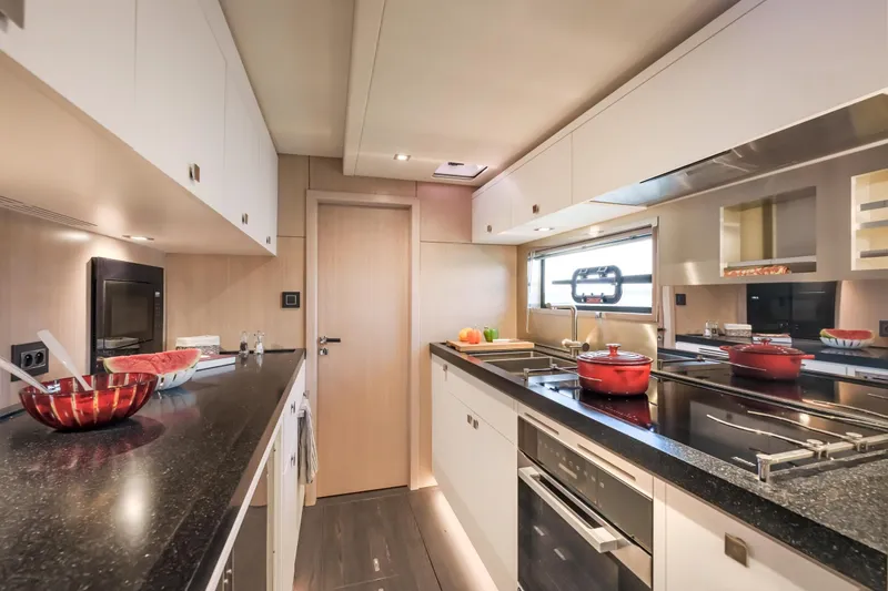 Slide: The Image of Modern kitchen interior in 2025 Privilege Signature 650 yacht, featuring sleek countertops and appliances. - 37