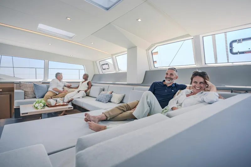 Slide: The Image of Luxurious interior of 2025 Privilege Signature 650 yacht with relaxed passengers. - 18