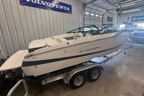 The Image of 2027 Regal LS2 boat on trailer in indoor showroom. - 1