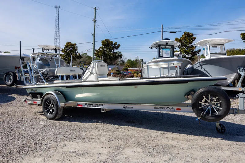 Slide: The Image of 2024 Maverick 17 HPX-S boat on trailer at dealership, surrounded by other boats. - 6