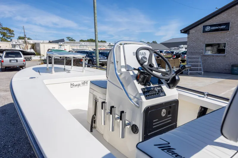 Slide: The Image of 2024 Maverick 17 HPX-S boat with steering console, parked outdoors near Mercury building. - 11