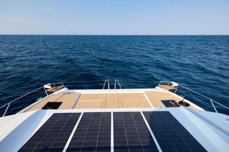 Slide: The Image of Custom Omaya 50 Power Catamaran 2025, featuring solar panels, cruising on open sea. - 18