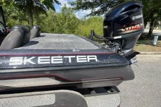 Slide: The Image of 2014 Skeeter ZX200 boat with Yamaha VMAX engine, parked outdoors. - 5