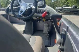 Slide: The Image of 2014 Skeeter ZX200 boat cockpit with steering wheel and controls, outdoors. - 8