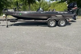 The Image of 2014 Skeeter ZX200 boat on trailer, parked outdoors on a sunny day. - 1