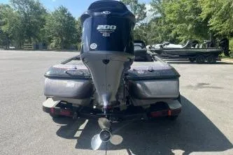 Slide: The Image of 2014 Skeeter ZX200 boat with powerful engine, parked outdoors on a sunny day. - 7
