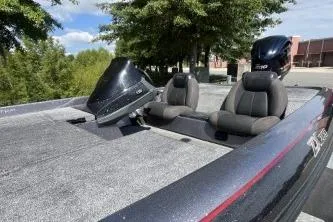 Slide: The Image of 2014 Skeeter ZX200 boat with dual seats and motor, parked outdoors. - 4