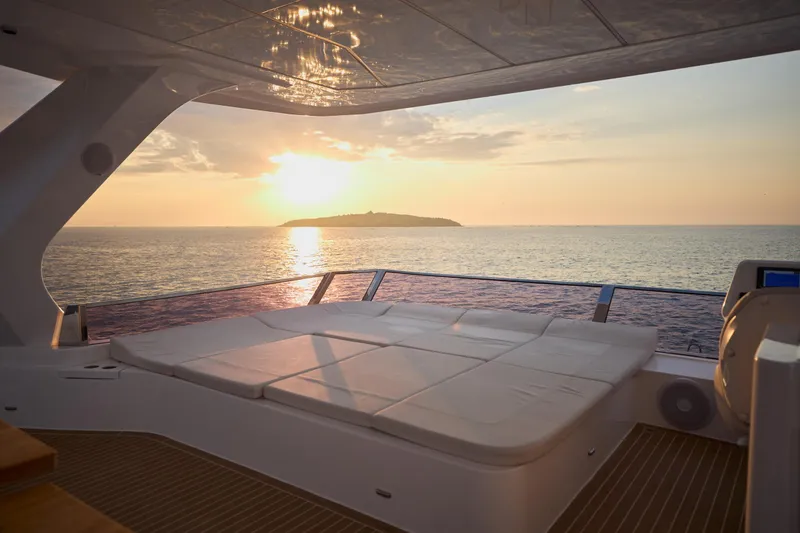 Slide: The Image of Luxurious Omaya 50 Power Catamaran at sunset, 2025 model, with ocean view and island backdrop. - 43