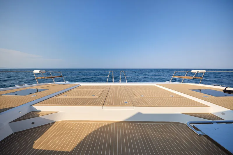 Slide: The Image of Custom Omaya 50 Power Catamaran 2025, spacious deck, ocean view, clear blue sky. - 19