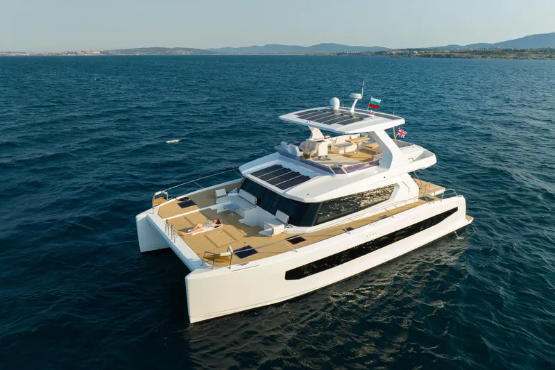 Slide: The Image of 2025 Custom Omaya 50 Power Catamaran cruising on open sea, showcasing luxury design and spacious deck. - 8