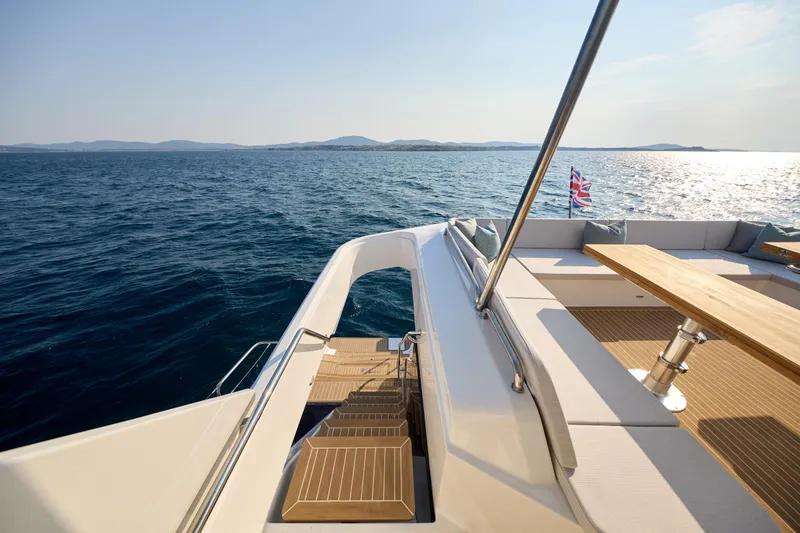 Slide: The Image of Luxurious 2025 Omaya 50 Power Catamaran deck with ocean view and seating area. - 36
