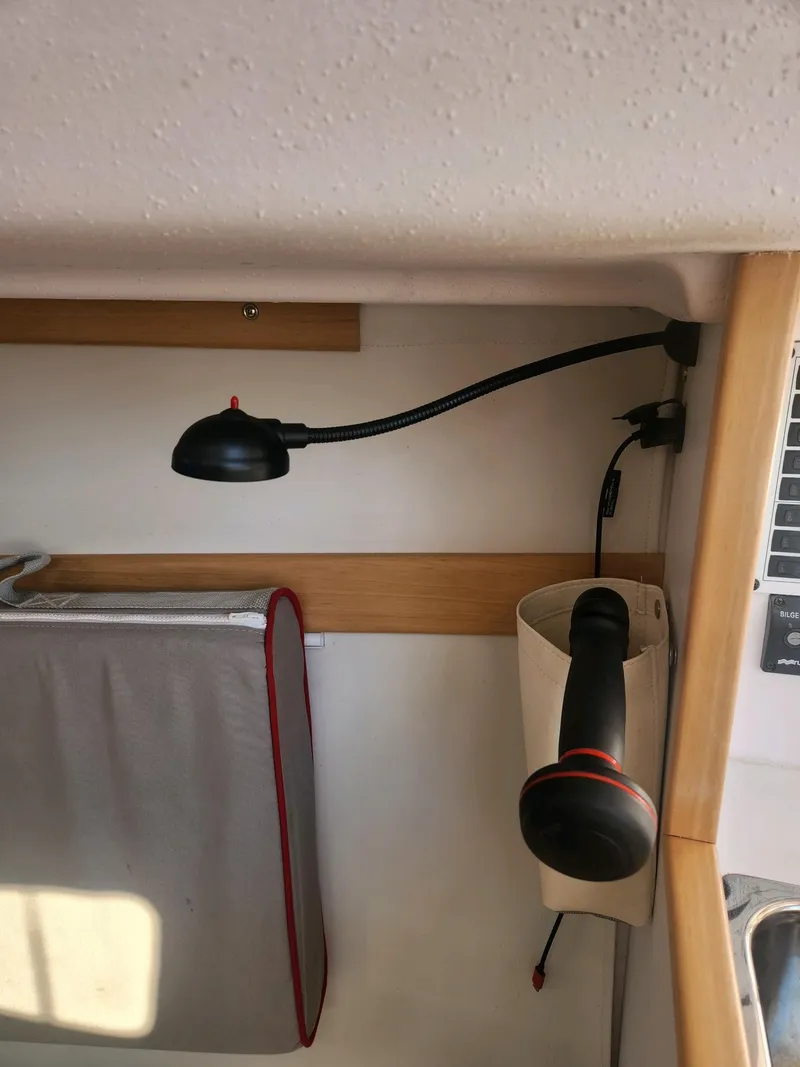 Slide: The Image of Interior of a 2015 Catalina 275 Sport with a reading lamp and storage area. - 21